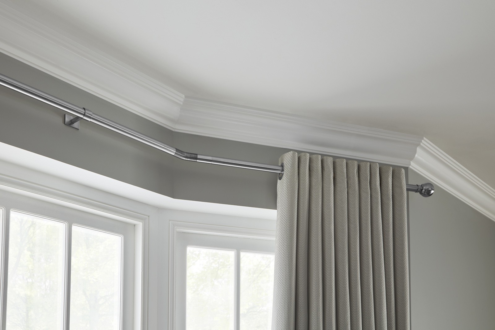 Eyelet curtains on bay window curtain pole